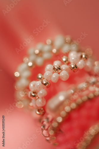 Beautiful handmade jewellery with colorful beads with flower shape in macro closeup. Selective focus. Hobby concept.