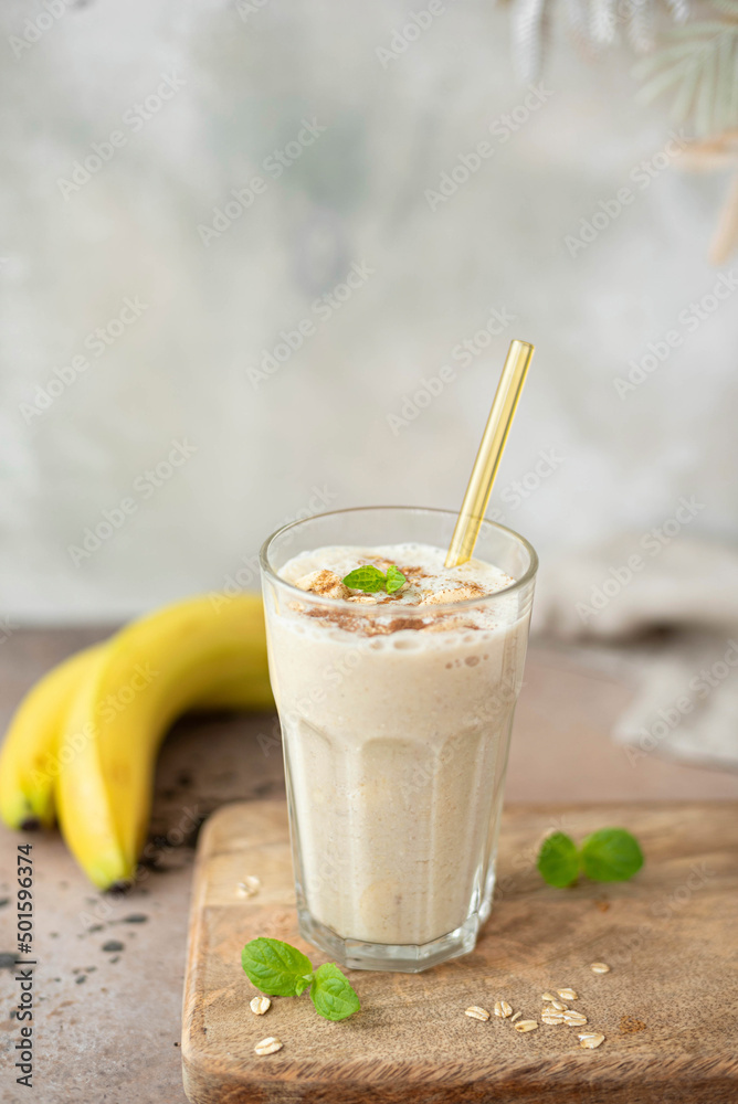 banana milkshake with oatmeal and cinnamon in a glass banana milkshake with oatmeal and cinnamon in a glass