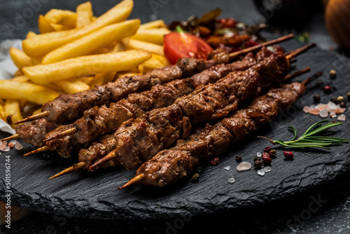 Grilled meat skewers, shish kebab with onion and sweet pepper. Georgian cuisine. hearty lunch or dinner, banner, menu, recipe place for text, top view