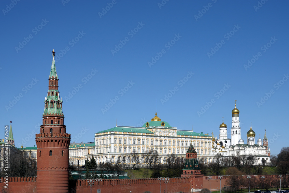 Vodovzvodnaya tower, Grand Kremlin Palace and Ivan the Great Bell Tower of Moscow Kremlin behind the wall on embankment ot the Moscow river on bright spring sunny day