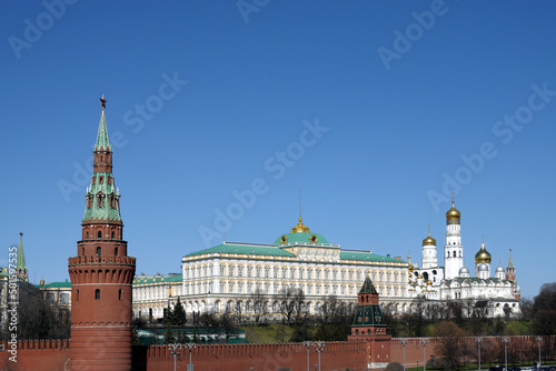 Vodovzvodnaya tower, Grand Kremlin Palace and Ivan the Great Bell Tower of Moscow Kremlin behind the wall on embankment ot the Moscow river on bright spring sunny day
