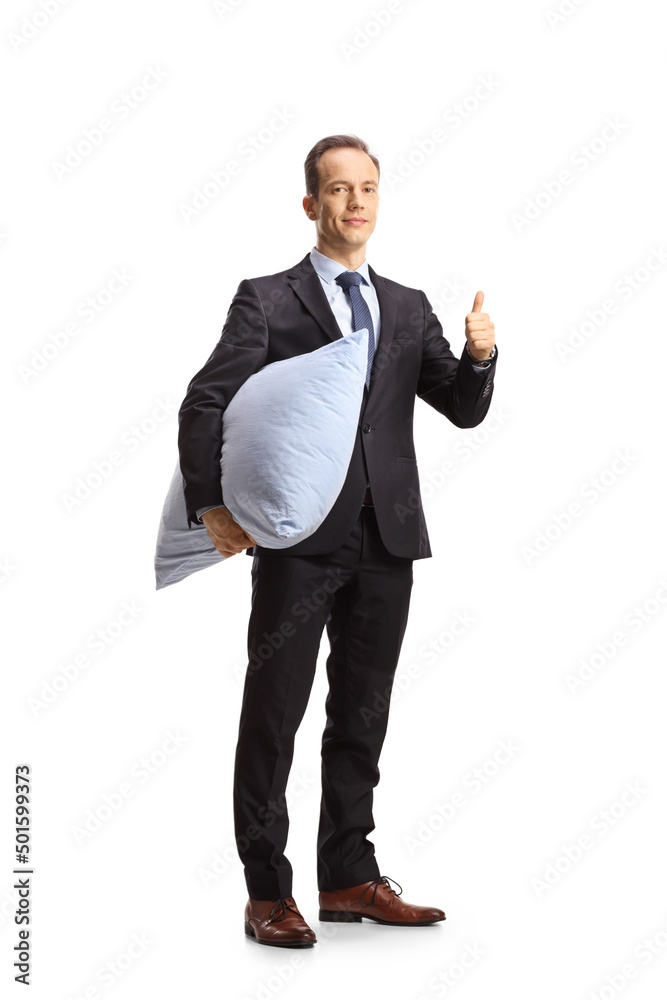 Businessman holding a pillow and showing thumbs up Businessman holding a pillow and showing thumbs up