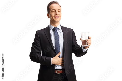Satisfied businessman with closed eyes holding a glass of water