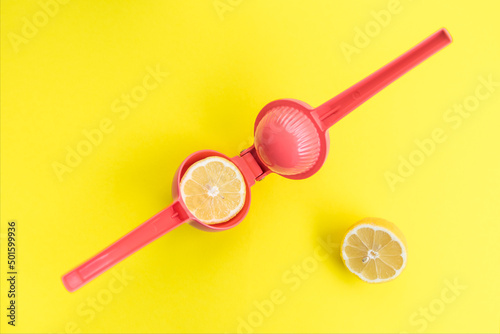 Squeezing a lemon with a pink lemon squeezer photo