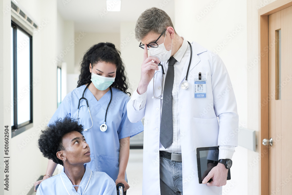 Doctor talking to a patient in wheelchair at hospital