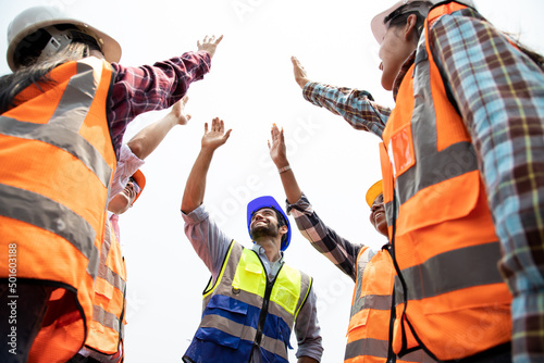 Engineer train teamwork holding hand up to sunny sky for showing successful sign after closed biggest projects. Train and transportation investment and maintenance concept
