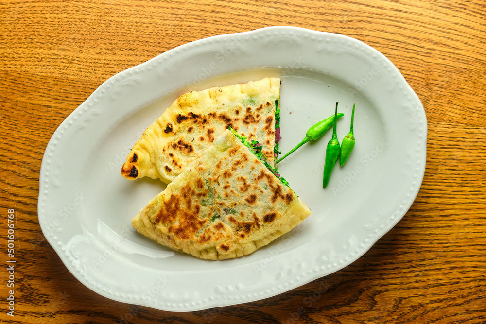 Flatbread stuffed with cheese and herbs. National Georgian dish Flatbread stuffed with cheese and herbs. National Georgian dish