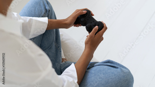 African American woman holding joystick in hands