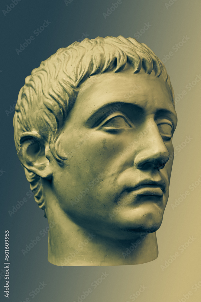 Bronze color gypsum copy of ancient statue of Germanicus Julius Caesar head for artists on brass background. Renaissance epoch. Plaster sculpture of man face. Template for art design Bronze color gypsum copy of ancient statue of Germanicus Julius Caesar head for artists on brass background. Renaissance epoch. Plaster sculpture of man face. Template for art design