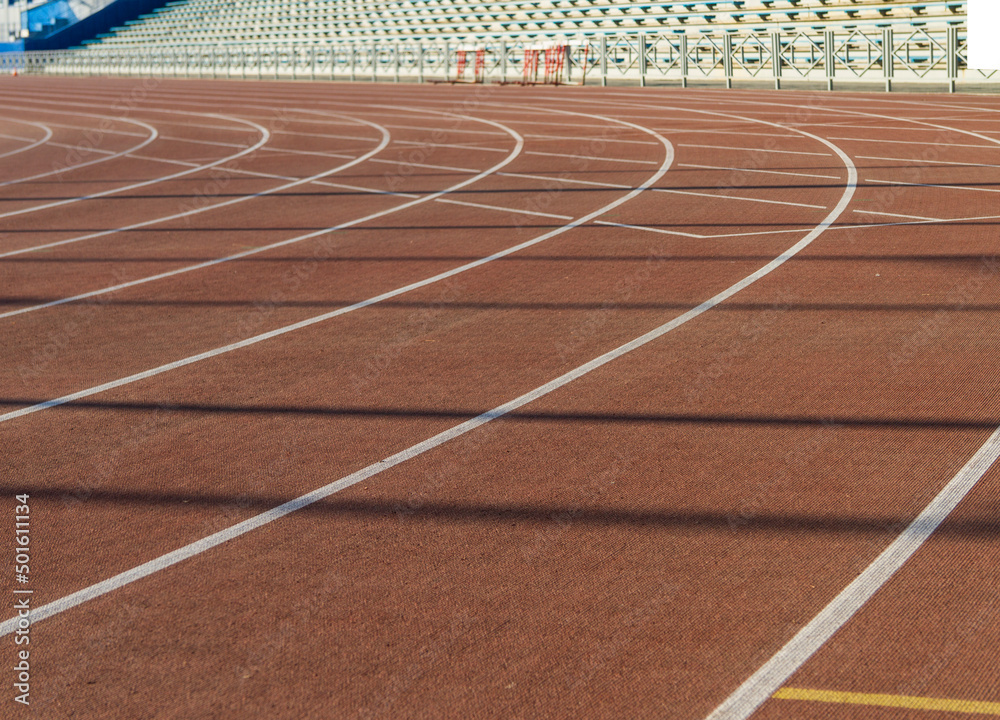 Orange running track with markings in the stadium.