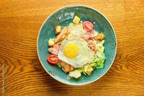 Caesar salad with large fried eggs