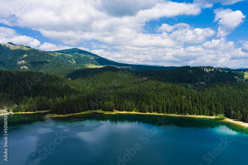 Montenegro. Zabljak. Durmitor National Park. Popular tourist spot. Black lake surrounded by green coniferous forest. Beauty of nature concept background. Drone. Aerial view