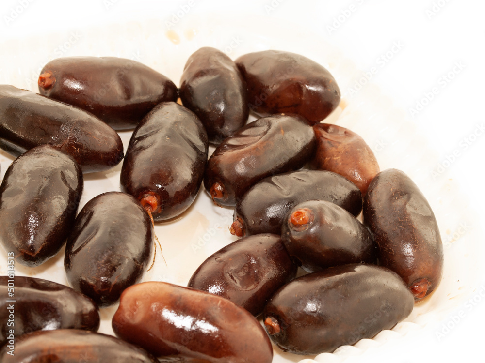 Fresh royal big dates around white background. close up Fresh royal big dates around white background. close up