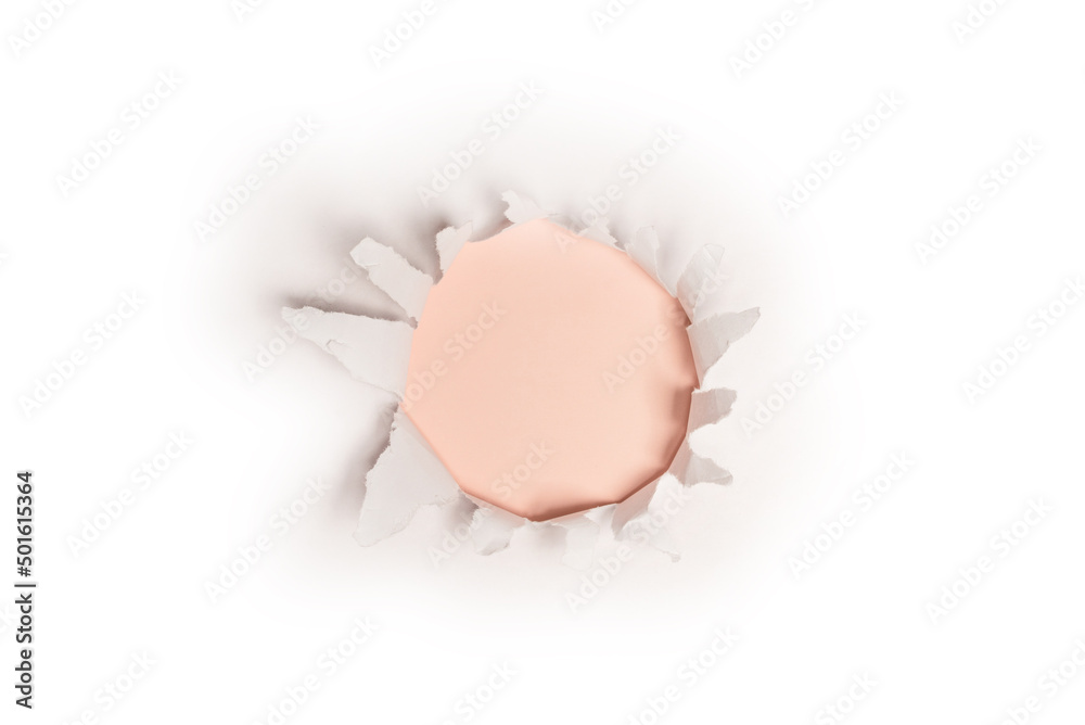 A hole in a white paper on a red background, copy space. A hole in a white paper on a red background, copy space.