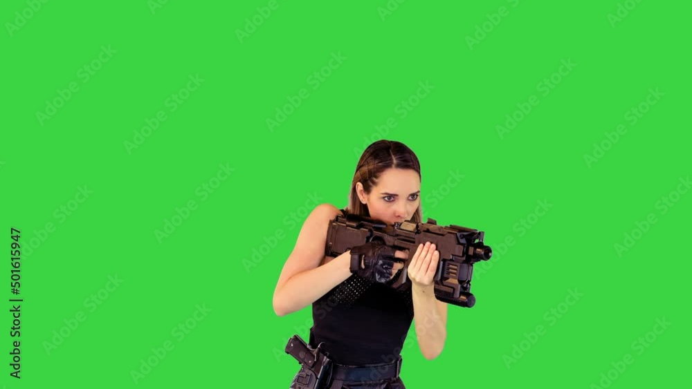 Cyberpunk girl walks with machine gun, taking an aim, making a single shot on a Green Screen, Chroma Key. Cyberpunk girl walks with machine gun, taking an aim, making a single shot on a Green Screen, Chroma Key.