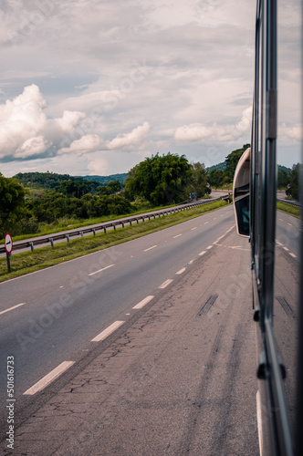 Um ônibus em uma estrada federal e bela paisagem ao redor photo