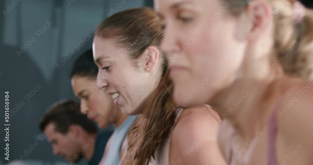 Women smile after finishing intense interval training workout on treadmills Women smile after finishing intense interval training workout on treadmills