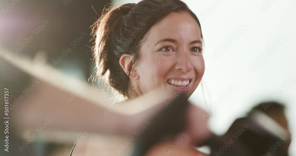 Happy woman smiles after finishing an intense interval training workout on a spin bike
