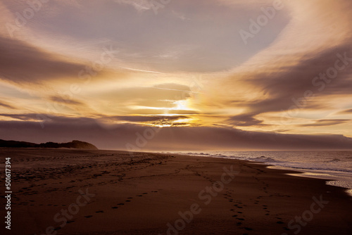 dark clouds at sunset on the sandy beach of Ouddorp near the Northsea