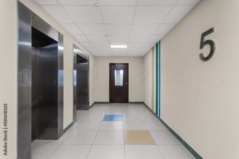 Fototapeta premium Modern public space of a residential building with elevators on the 5th floor