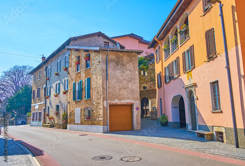 The old residential houses with modest facades at the main street of tiny Porza town in Lugano district, Switzerland photo