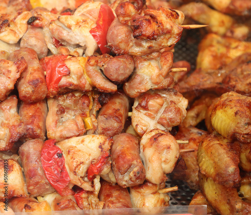 assorted grilled skewers displayed for sale-