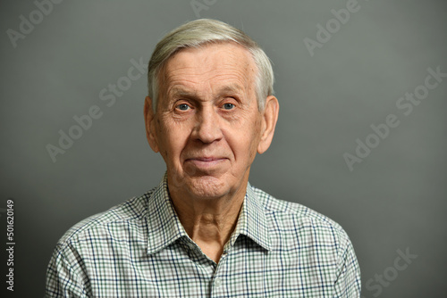 Studio portrait of smiling cheerful old man, 80 years old.