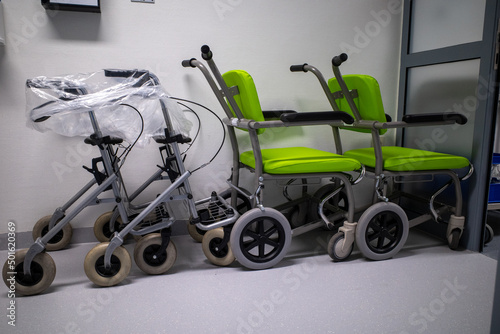in the corridor of a hospital there are several ambulance chairs