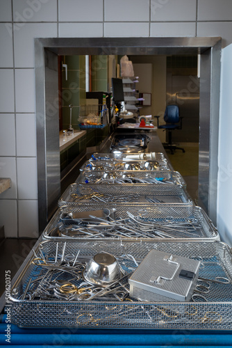 of a sterilization department in the hospital, cleaned surgical instruments stand on a conveyor belt