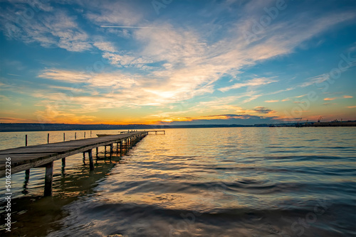 Stunning twilight at the shore with a wooden jetty