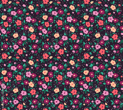 Beautiful floral pattern in small abstract flowers. Small colorful flowers. Violet background. Ditsy print. Floral seamless background. Vintage template for fashion prints. Stock pattern.