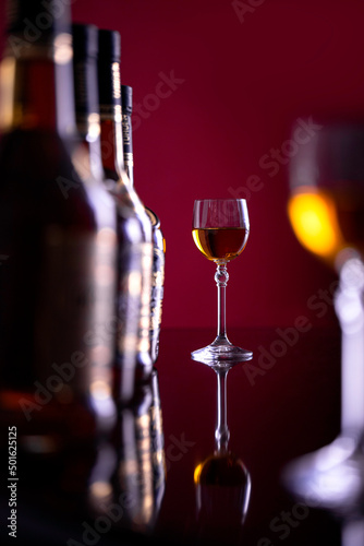 Two glasses of sparkling wine on the background of bottles