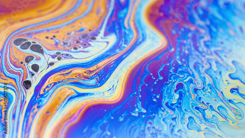 Macro photo of the texture of a soap bubble. Multicolored stripes.