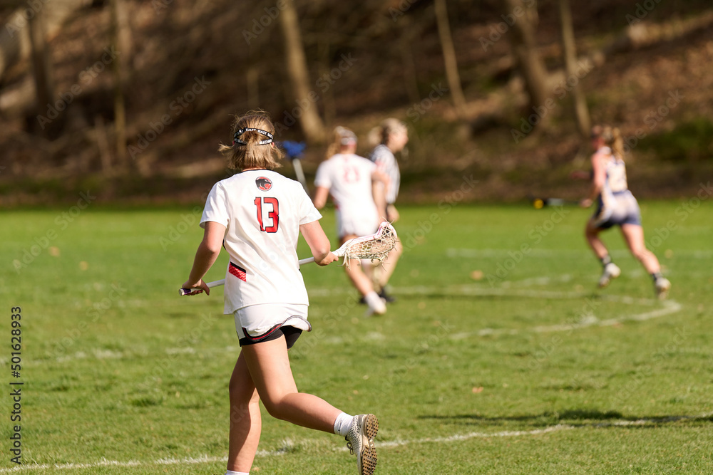 SEWICKLEY, PA, USA - APRIL13th 2022: Teenage girls from Sewickley Academy play senior school varsity lacrosse game against Freeport High School. There were lots of goals and action on this sunny day. SEWICKLEY, PA, USA - APRIL13th 2022: Teenage girls from Sewickley Academy play senior school varsity lacrosse game against Freeport High School. There were lots of goals and action on this sunny day.