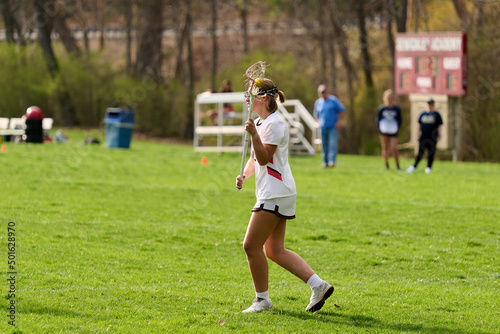 SEWICKLEY, PA, USA - APRIL13th 2022: Teenage girls from Sewickley Academy play senior school varsity lacrosse game against Freeport High School. There were lots of goals and action on this sunny day.