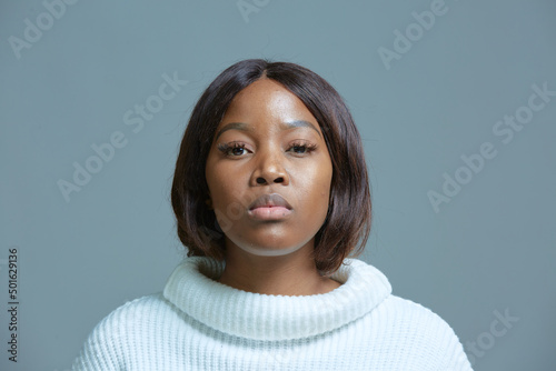 Serious displeased african american woman. Pensive offended millennial black female looking at camera with suspicion
