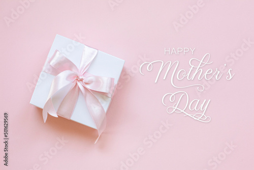 Happy Mothers Day lettering and a gift box on pink background.
Happy mothers day lettering on pink background.
