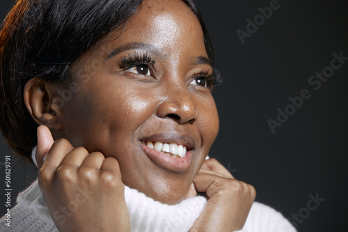 Smiling african american black woman looks up with hope, dreaming, feels happiness, inspiration. Closeup studio portrait