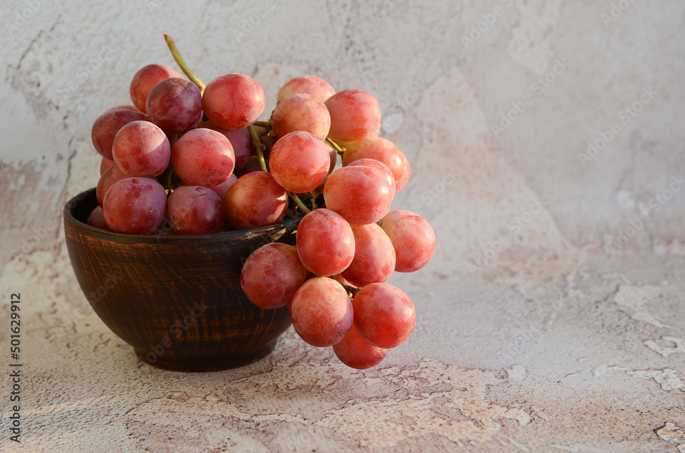 Bunch of grapes. Ripe large grape berries in a ceramic bowl on an abstract background. Vine. Bunch of grapes. Ripe large grape berries in a ceramic bowl on an abstract background. Vine.