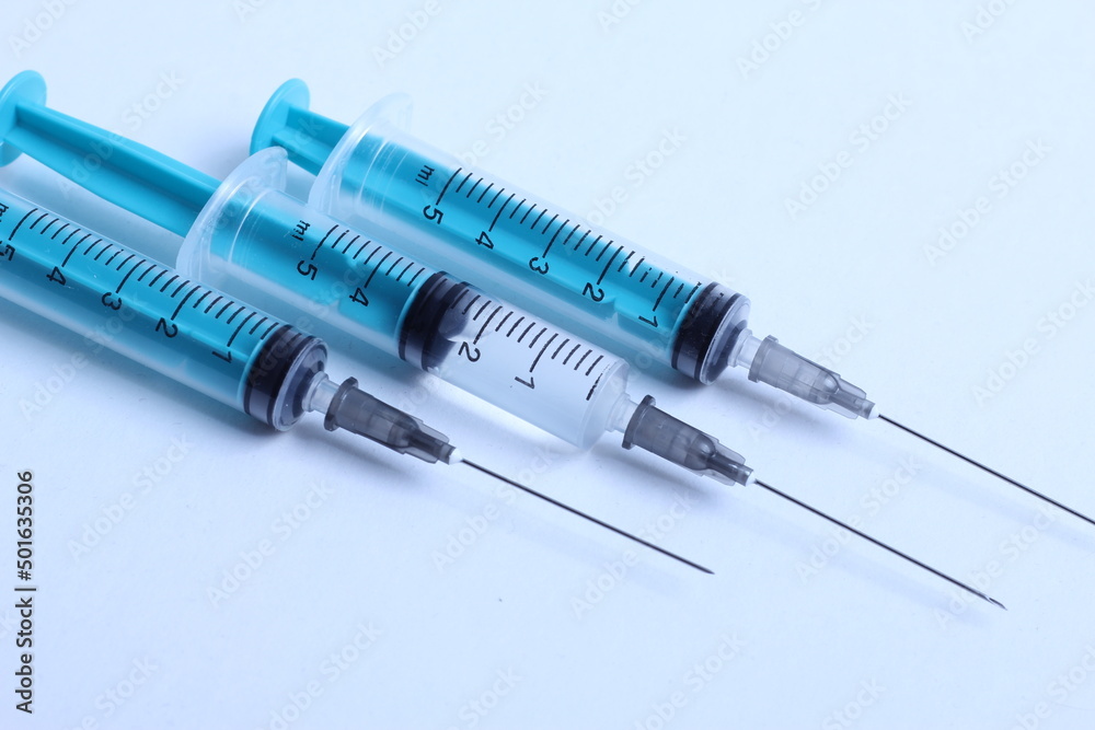 Medical syringe on a white background. A syringe for injection. The concept of health and beauty Medical syringe on a white background. A syringe for injection. The concept of health and beauty