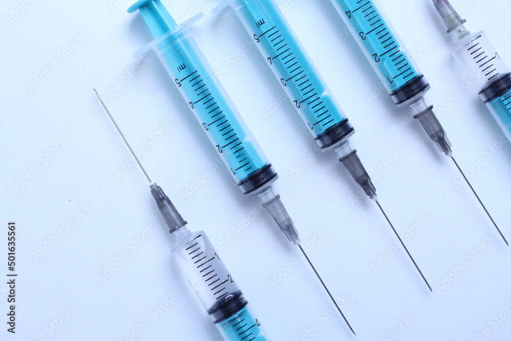 Medical syringe on a white background. A syringe for injection. The concept of health and beauty Medical syringe on a white background. A syringe for injection. The concept of health and beauty