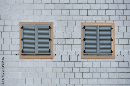 Gray plastic window sashes on brick wall