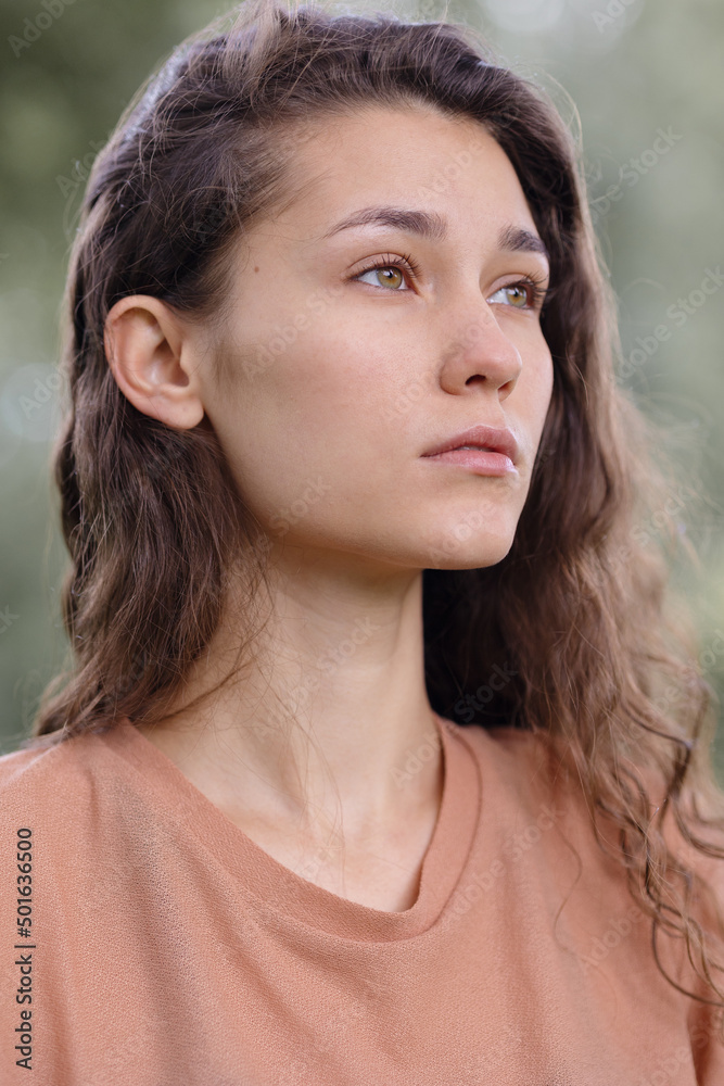 a woman with curly hair meditates in the park. yoga and meditation for mental and physical health. a beautiful young woman calmly looks thoughtfully and engages in breathing and spiritual practices a woman with curly hair meditates in the park. yoga and meditation for mental and physical health. a beautiful young woman calmly looks thoughtfully and engages in breathing and spiritual practices