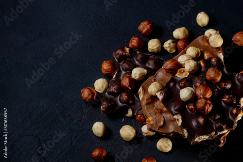 Top view in section on a bar of dark chocolate with hazelnuts