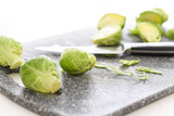 Brussels sprouts on cutting board with knife