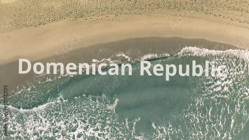 Domenican Republic words being revealed with the shadow of a flying airplane on the beach photo