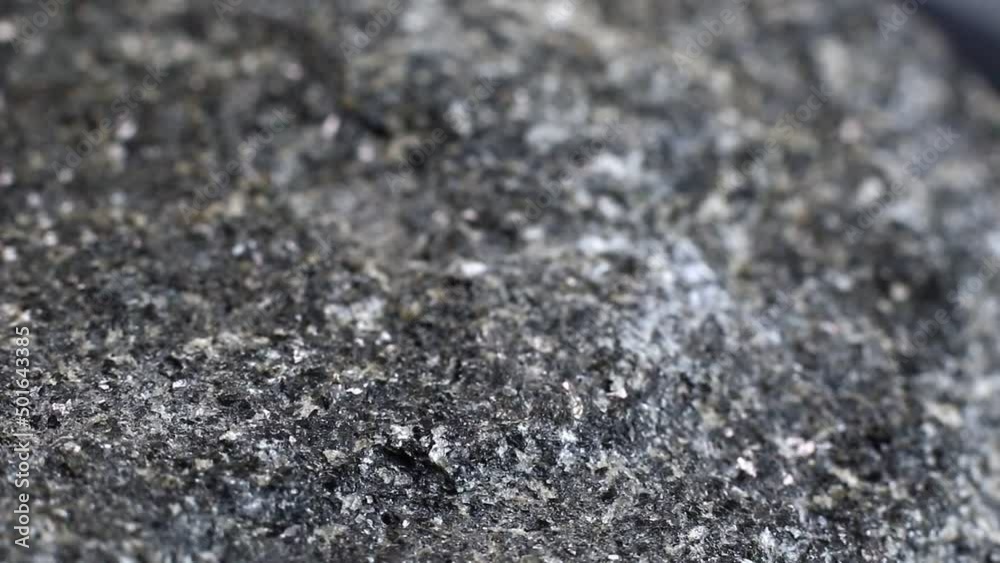 Macro close up of a hard rough granite rock texture
Macro close up of a hard rough granite rock texture