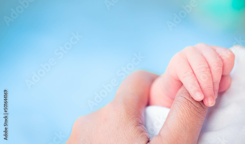 Baby infant finger hand with mother loving care.World baby day.Newborn cute.Mom and her Child.Premature or preterm baby in hospital.incubator intensive safe.foster child.Orphans infant.black people. photo