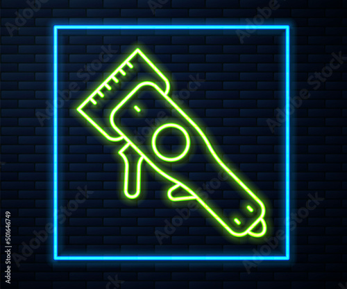 Glowing neon line Electrical hair clipper or shaver icon isolated on brick wall background. Barbershop symbol. Vector