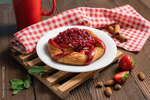 Fresh delicious puff pastry with sweet berries on dark wooden table, closeup